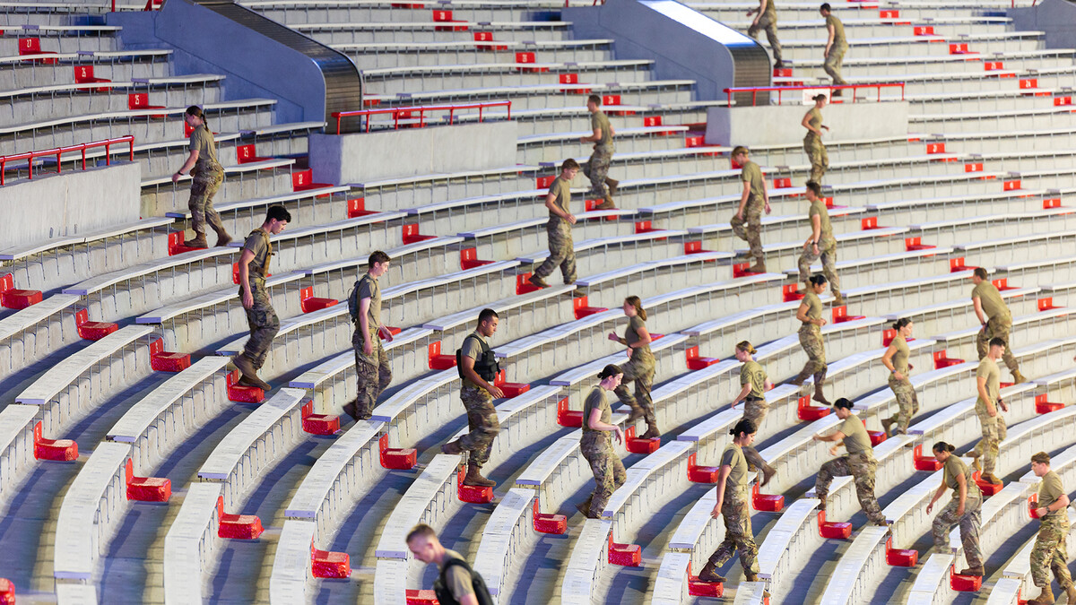 ROTC cadets climb stairs in Memorial Stadium for a 9/11 observance.