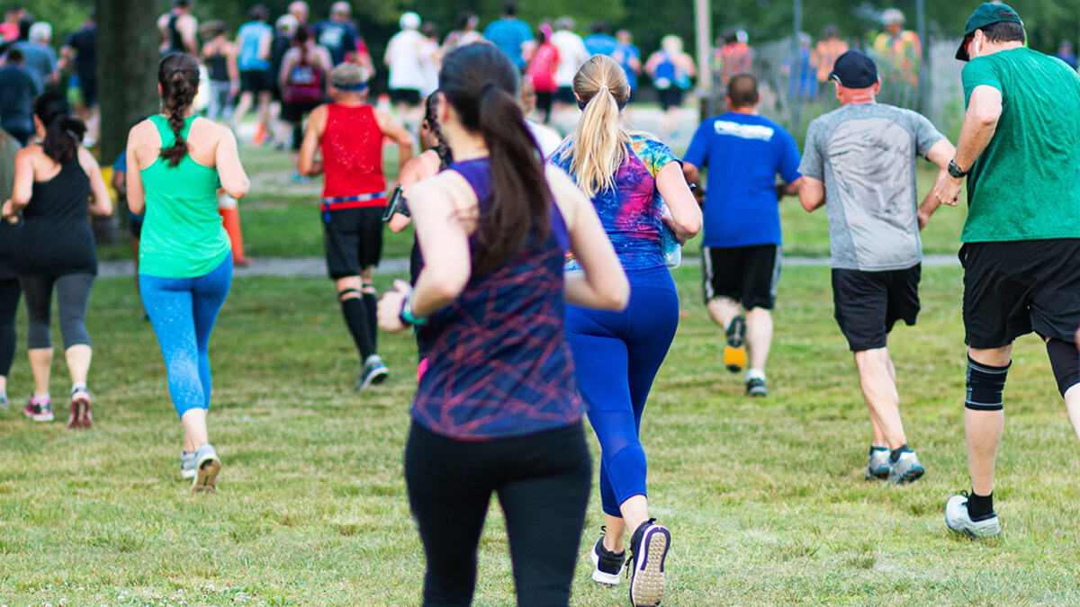 Runners begin a 5K on grass