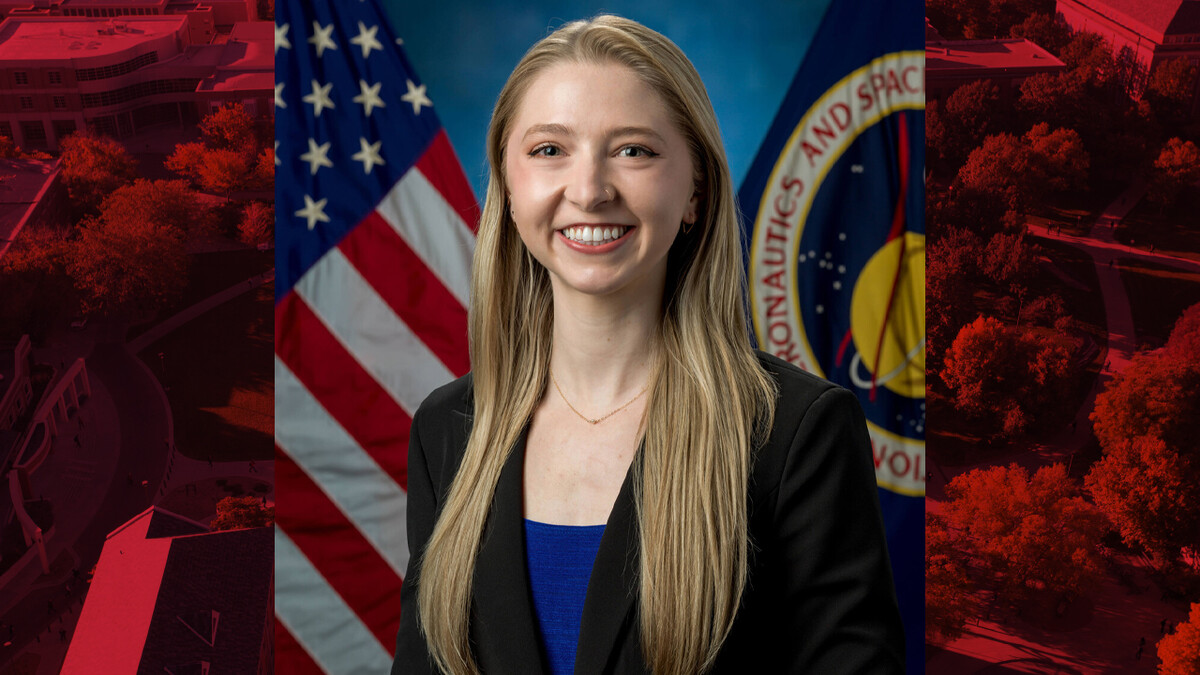 Headshot of Allison Porter Carpenter sitting in front of a USA flag and a NASA flag.