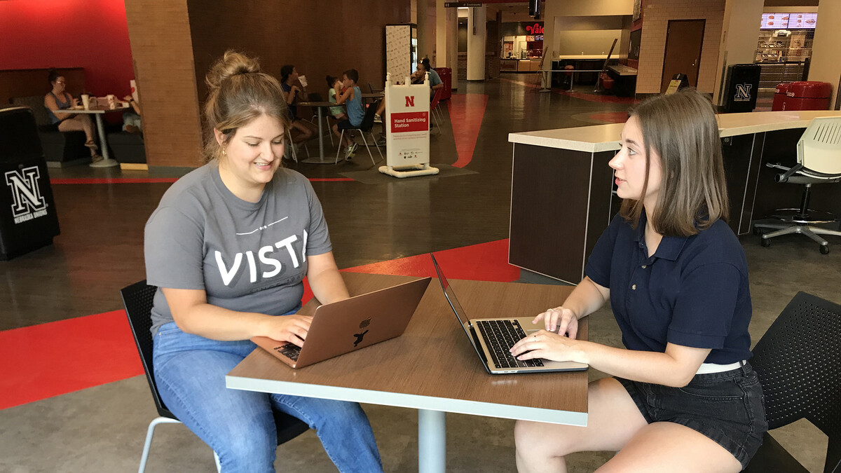 Candace Hulbert, the Weather Ready Farms VISTA, talks with Julien Hoffman, AmeriCorps VISTA program coordinator with Nebraska Extension, in the Nebraska Student Union