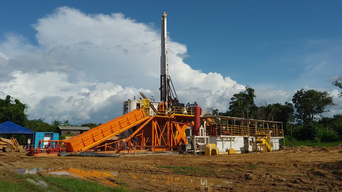 A drill rig stands in the Amazon rainforest.