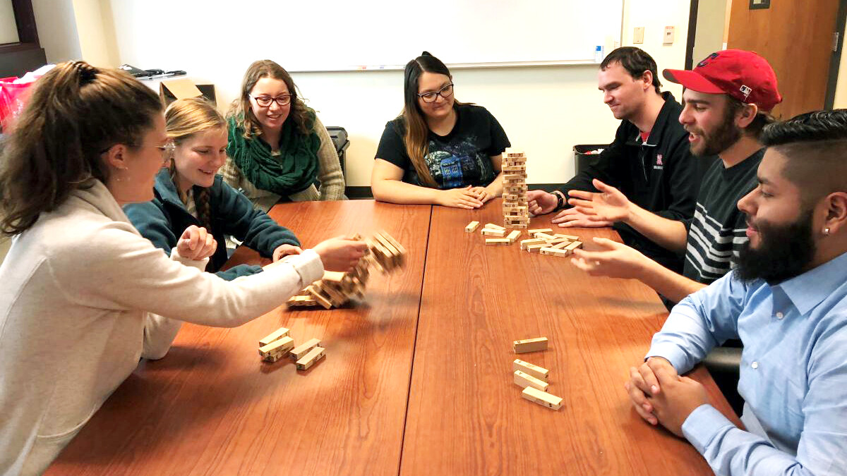 CRE students number the blocks in the game Jenga and play it with special rules to teach resilience concepts. Pictured are, from left, Julie Fowler, Jessica Johnson, Alison Ludwig, Rubi Quiñones, Conor Barnes, Dominic Cristiano and Daniel Morales.