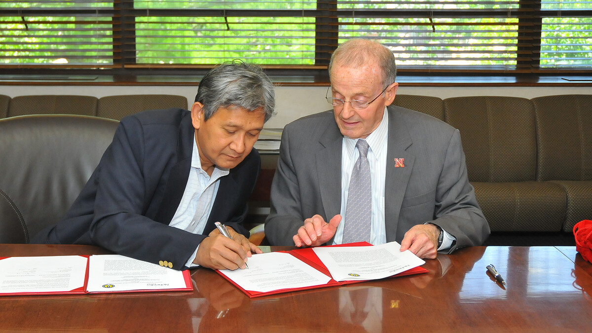 (From left) Rochmat Wahab, rector of Yogyakarta State University, and Harvey Perlman, UNL chancellor, sign a memorandum of understanding between the two universities on June 2.