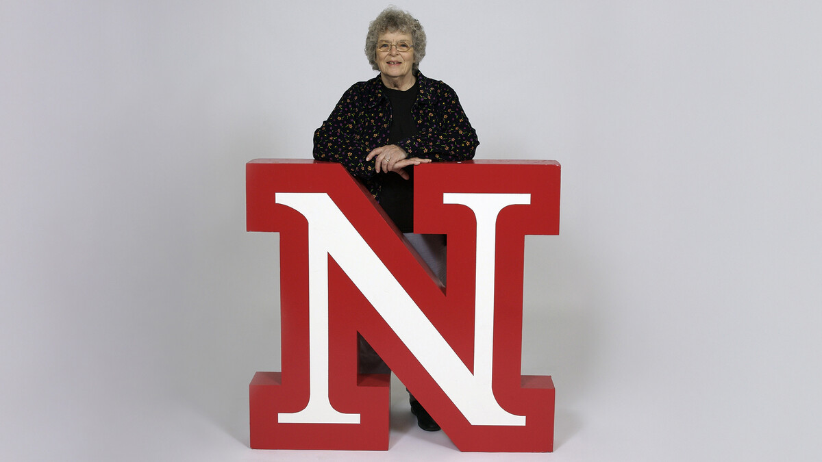 Lois Brinton stands by the now retired Academic "N" in a campus photo studio.