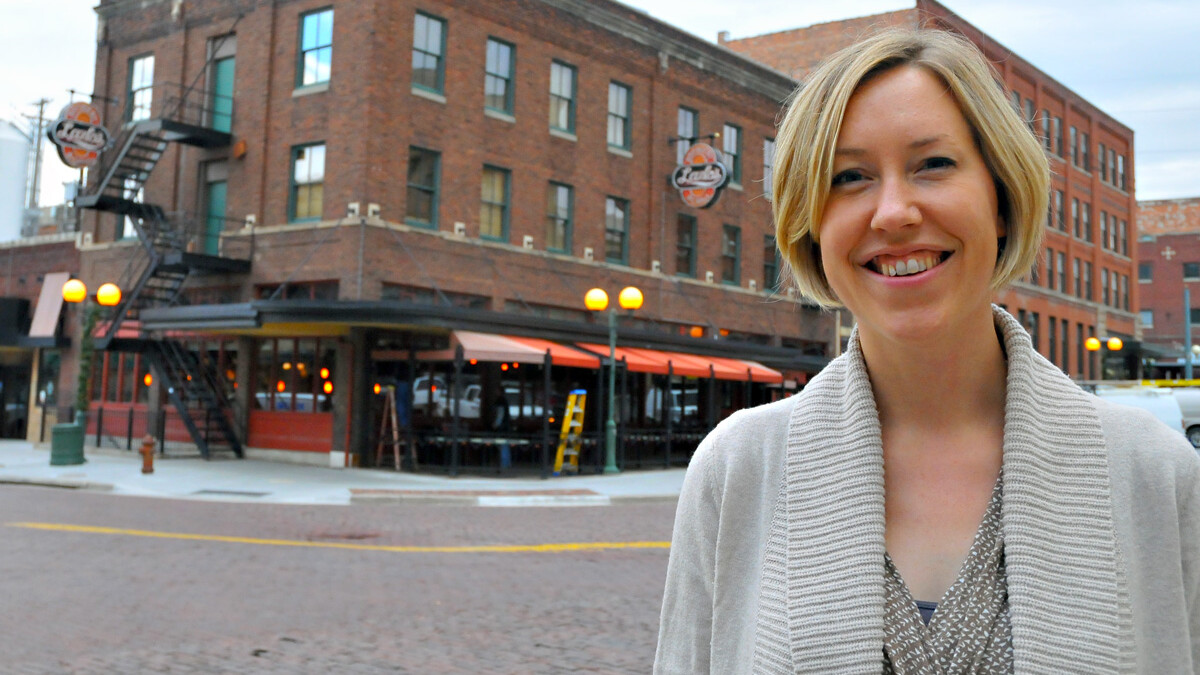 Jenny Dauer, assistant professor of practice, stands across the street from Lazlo's in the Haymarket. The buliding — along with others around Lincoln — was designed and built by Dauer's great-great-grandfather, John G. Cordner. The building was originally called the Bennett Hotel.