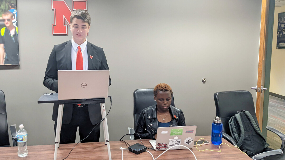 Nick Wallenburg (left), a junior, speaks during the debate with iDebate Rwanda students Feb. 18.