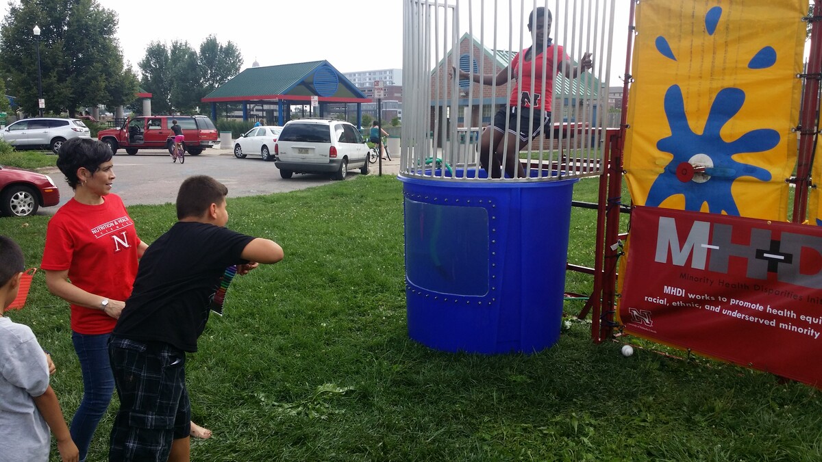 Bridget Goosby, associate professor of sociology and faculty member of the Minority Health Disparities Initiative, awaits a dunk in the tank during the Dunk the Doctor event at the Back to School Jam at Lincoln’s Malone Community Center Aug. 9. The Dunk the Doctor event is one of several community outreach activities MHDI is taking on to strengthen relationships among Nebraska communities and UNL researchers.