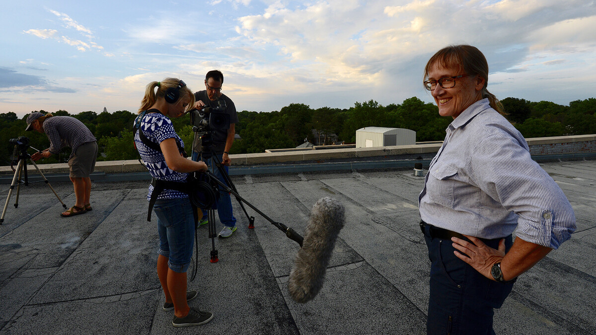 Nebraska's Mary Bomberger Brown (right) smiles as a crew prepares for an interview. Bomberger Brown, a Nebraska graduate and faculty member, dedicated her career to conservation, especially with endangered bird populations.