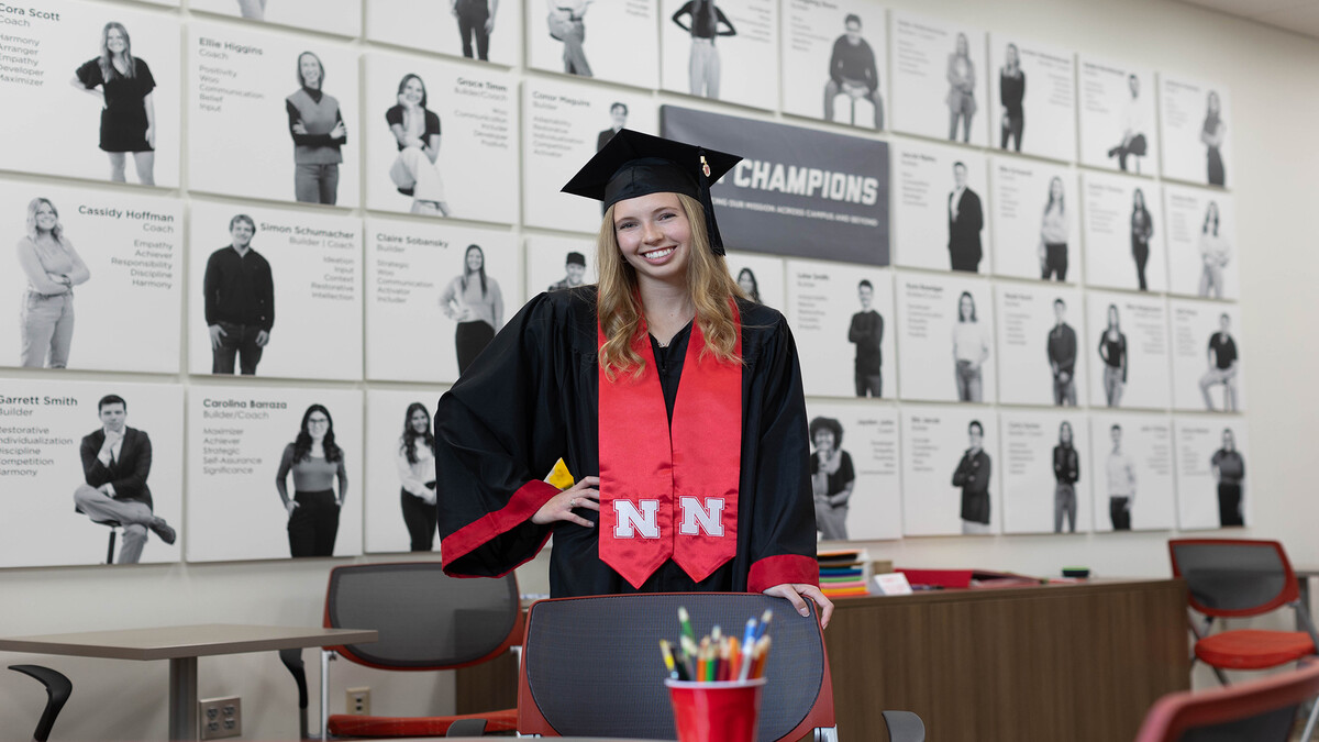 Jordan Westbroek stands in the center of the photo in her black cap and gown.