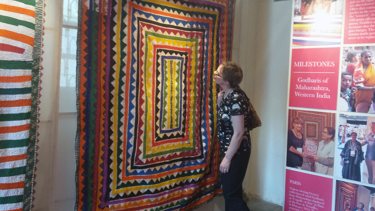 Marin Hanson, curator of exhibits at UNL's International Quilt Study and Museum, examines a quilt during a recent trip to India. Hanson and Leslie Levy, executive director of the museum, went to India to expand the quilt museum's international contacts.