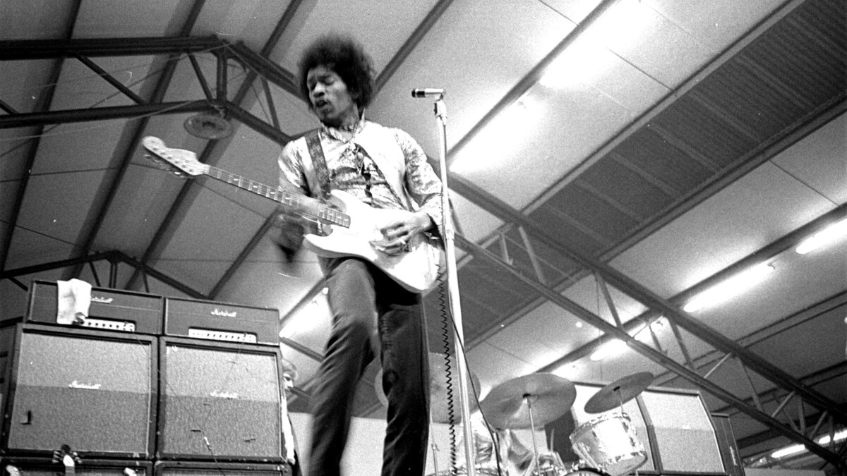 Jimi Hendrix performs on stage in 1967.