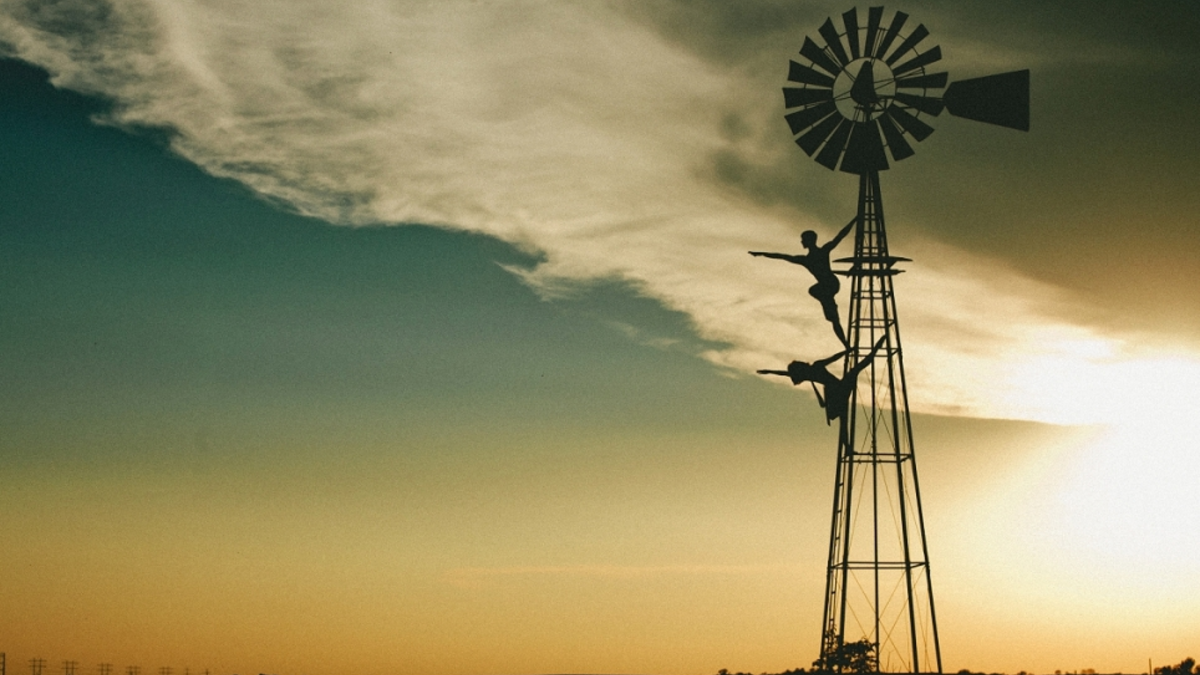 Dancers Ben Rivera and Sally Glaze posing on a windmill.