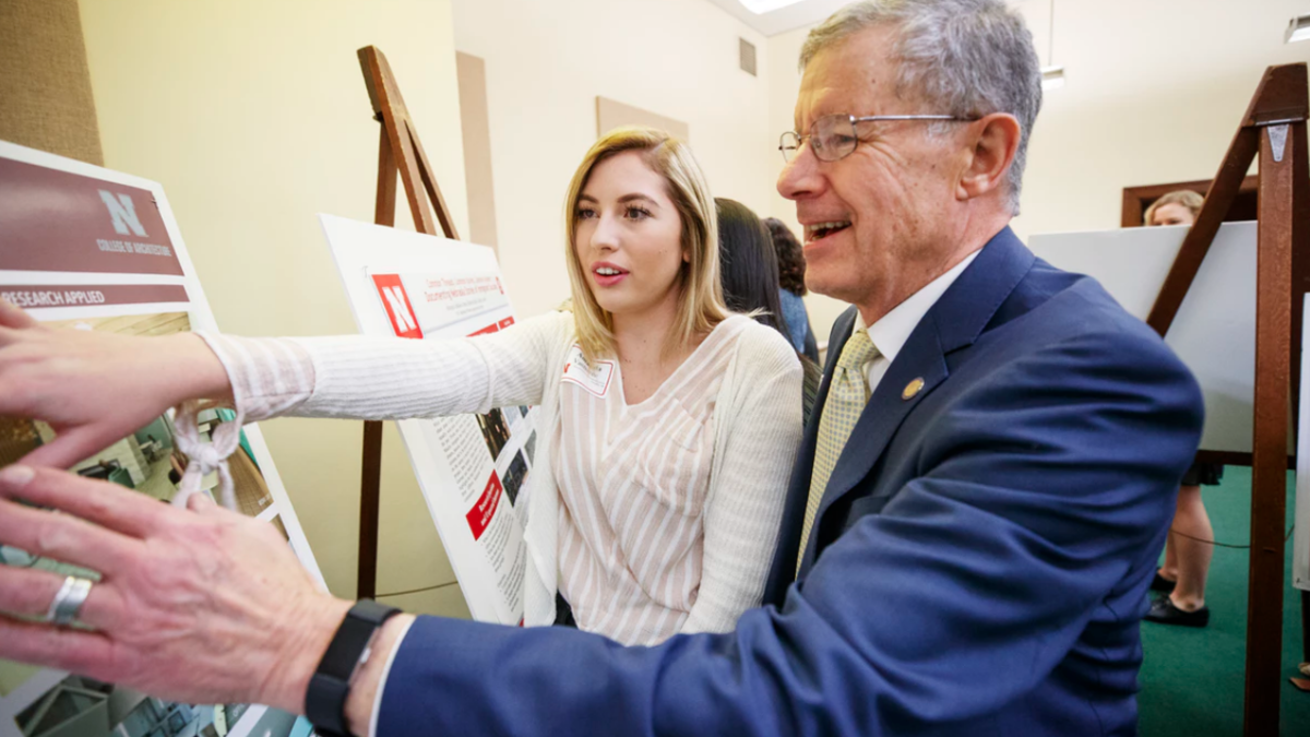 Sen. John S. McCollister and Amanda VanBuren discuss her research on the design of outpatient healthcare facilities.