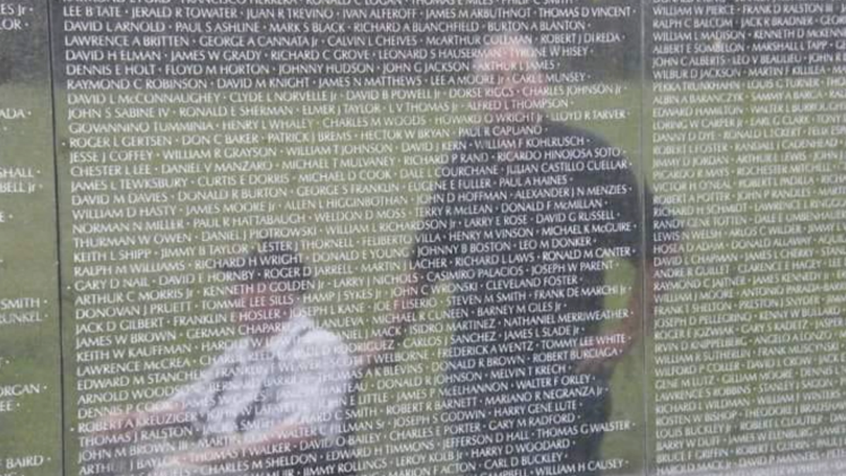 Veterans reflected on a wall at the Vietnam Veterans Memorial in Washington, D.C.