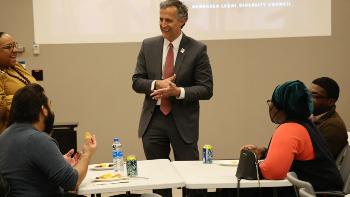 Richard Moberly, dean of law, talks with students during a college event.