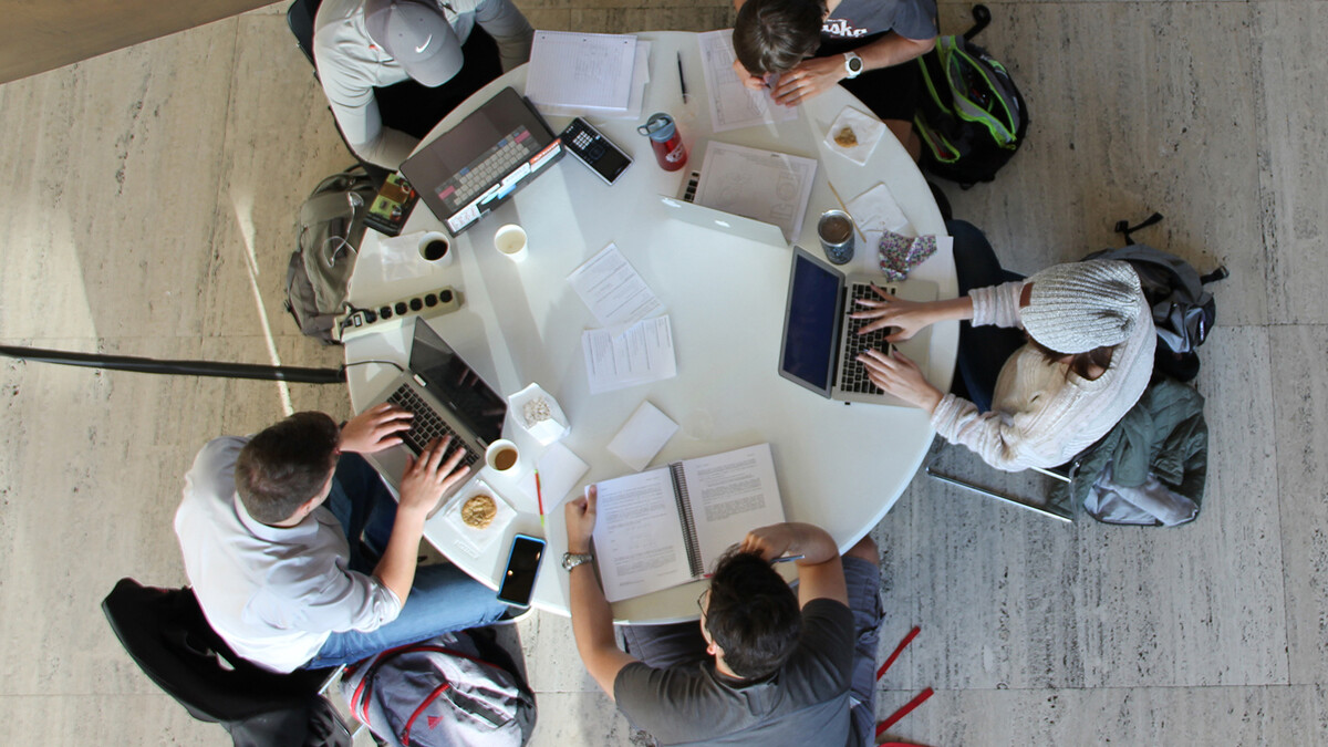 Students study at a table in Sheldon's Great Hall.