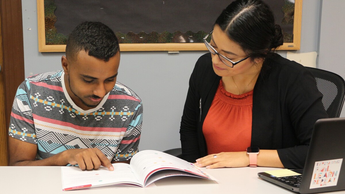 Career Advisor Letty Garcia helps a student develop his resume.