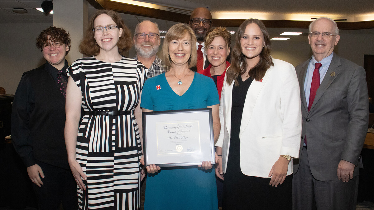 Sue Ellen Pegg received the Kudos award during the June 19 meeting of the University of Nebraska Board of Regents. She is pictured here (front, center) with family, friends, colleagues and university leaders.