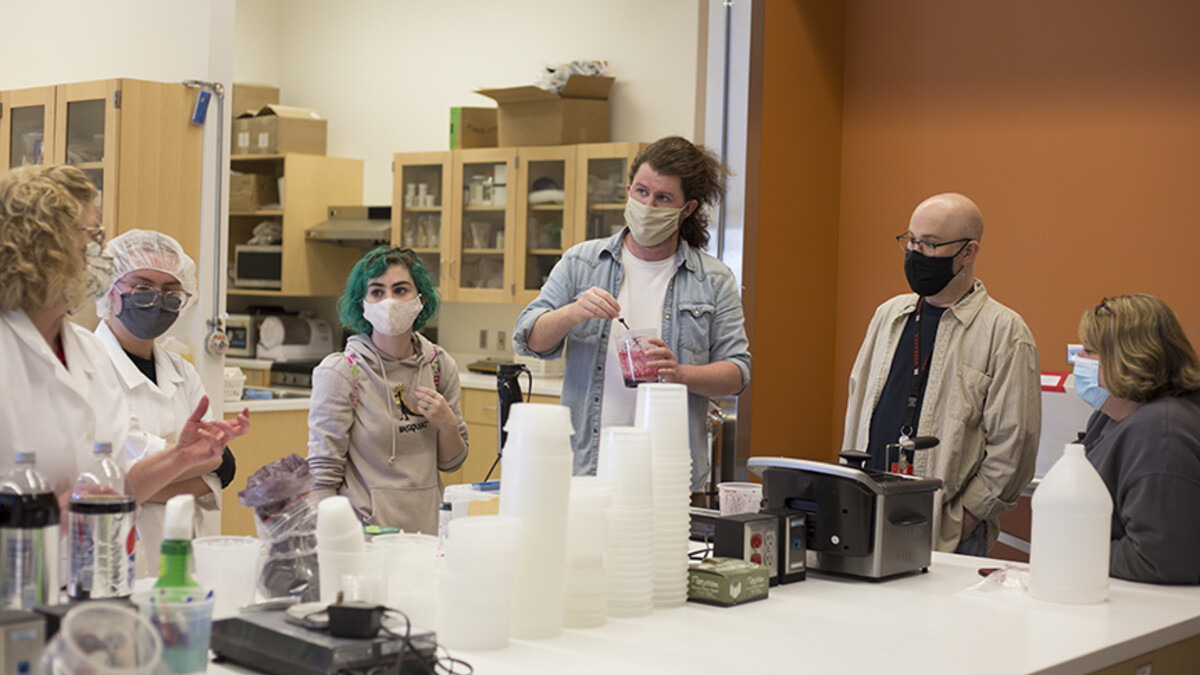 “Dracula: Mina’s Quest.” Right: (Left to right) Bethany Jackson, Zoe Kraus, Camille Lerner, Nathan Alexander, Jamie Bullins and Julie Reiling work on the perfect formula for the blood used in “Dracula: Mina’s Quest” at the Food Innovation Center. Photo by