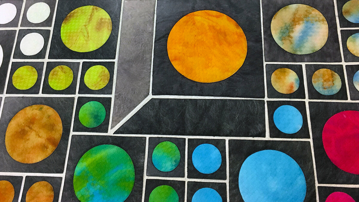 "Going with the Flow" by Olga Prins Lukowski was one of nine eclipse-themed quilts on display at the International Quilt Study Center and Museum on Aug. 19-20. The design features jewel-like celestial objects.