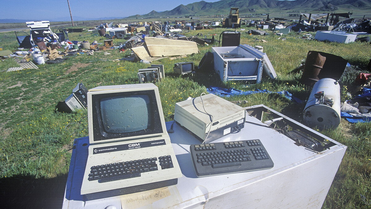 Old computer and electronic parts rotting in a junkyard.