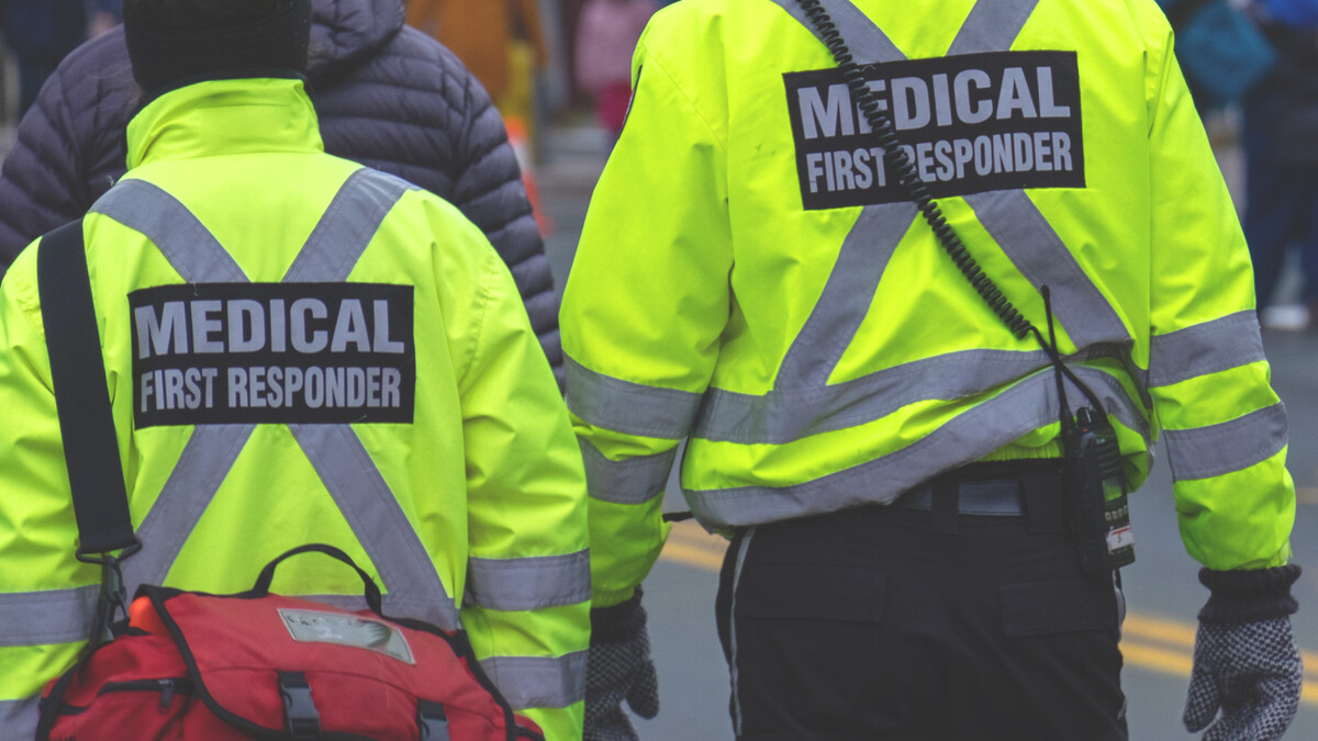 Emergency Medical Technicians approach a scene.