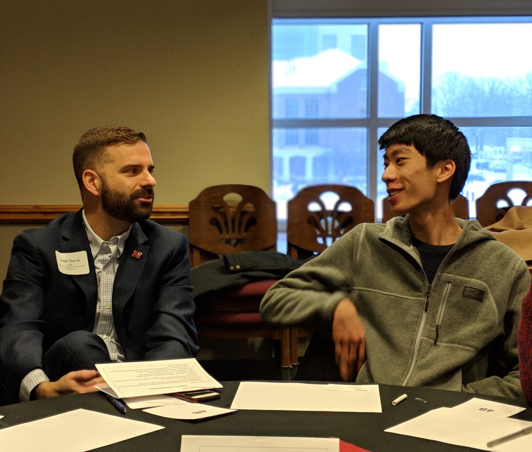 Josh Davis, IANR assistant vice chancellor for global engagement, meets one of his assigned students at a Dinner in a Nebraska Home reception in Spring 2018.