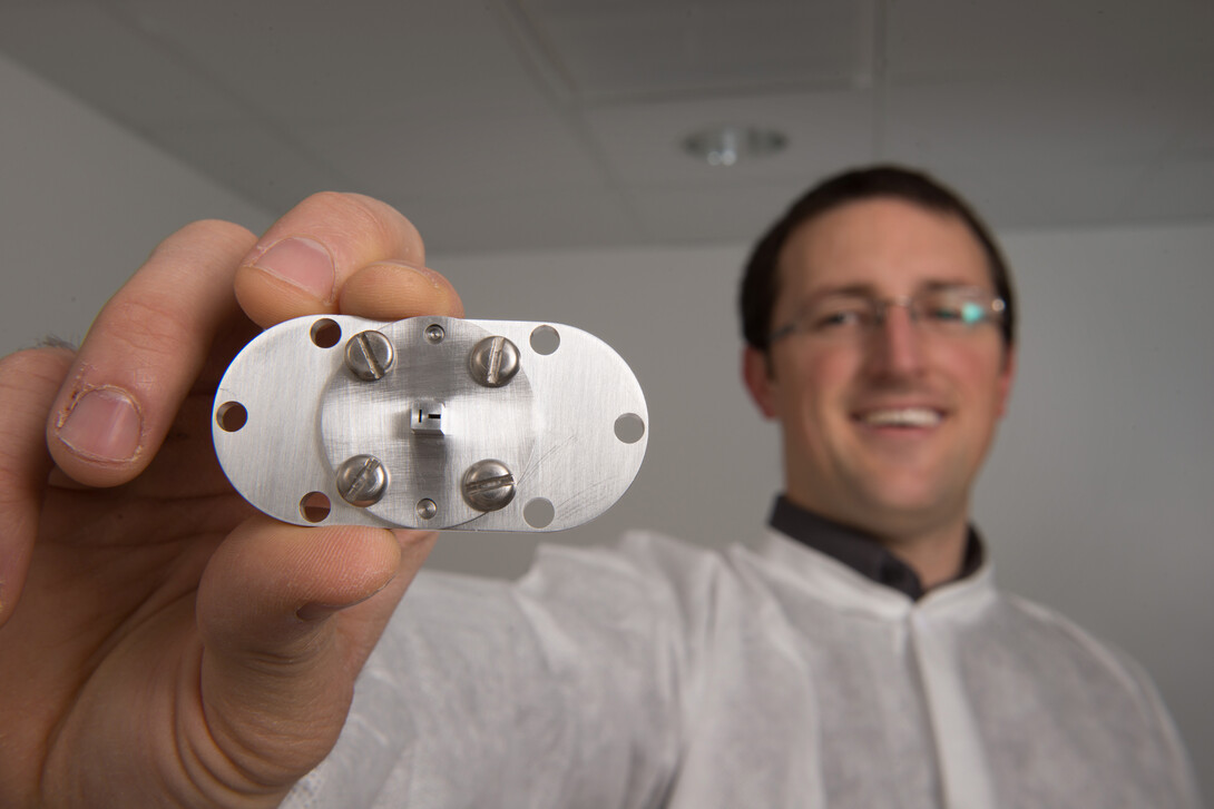 doctoral student Nathan Powers displaying the accelerator used to create synchrotron X-rays