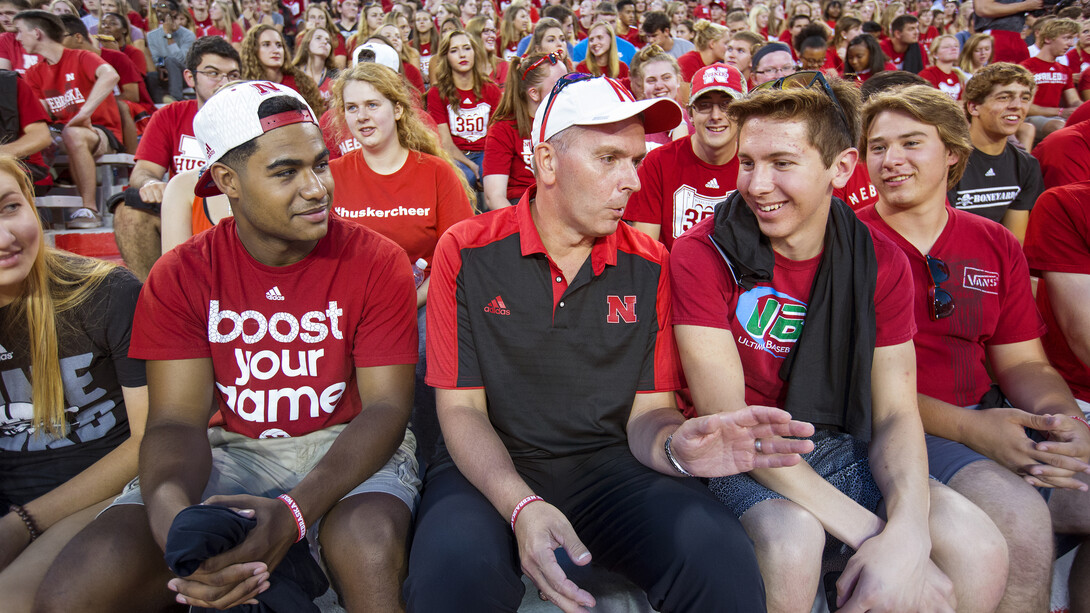Chancellor Ronnie Green (center) offers some first week advice to freshman Hunter Buresh of Lincoln (right), as he talked with students prior to the Bone Yard Bash and New Student Tunnel Walk on Aug. 27.