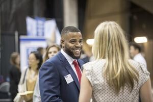 Student talks with employer at Business & Liberal Arts Career Fair.