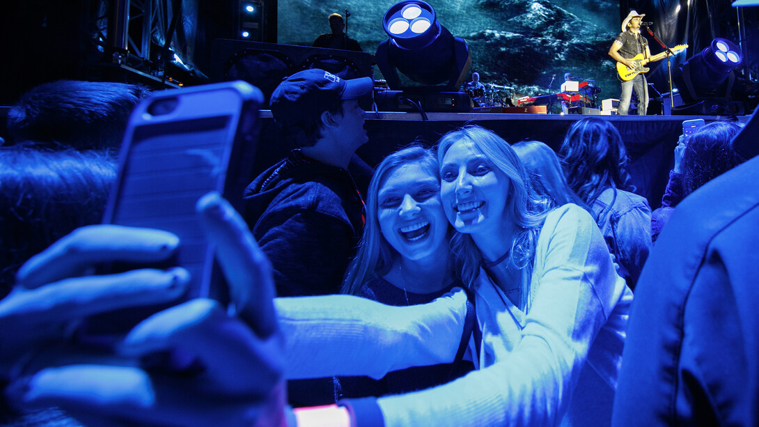 Nebraska students pose for a selfie as Brad Paisley plays on stage during a free Oct. 13 concert on City Campus. The concert drew thousands.