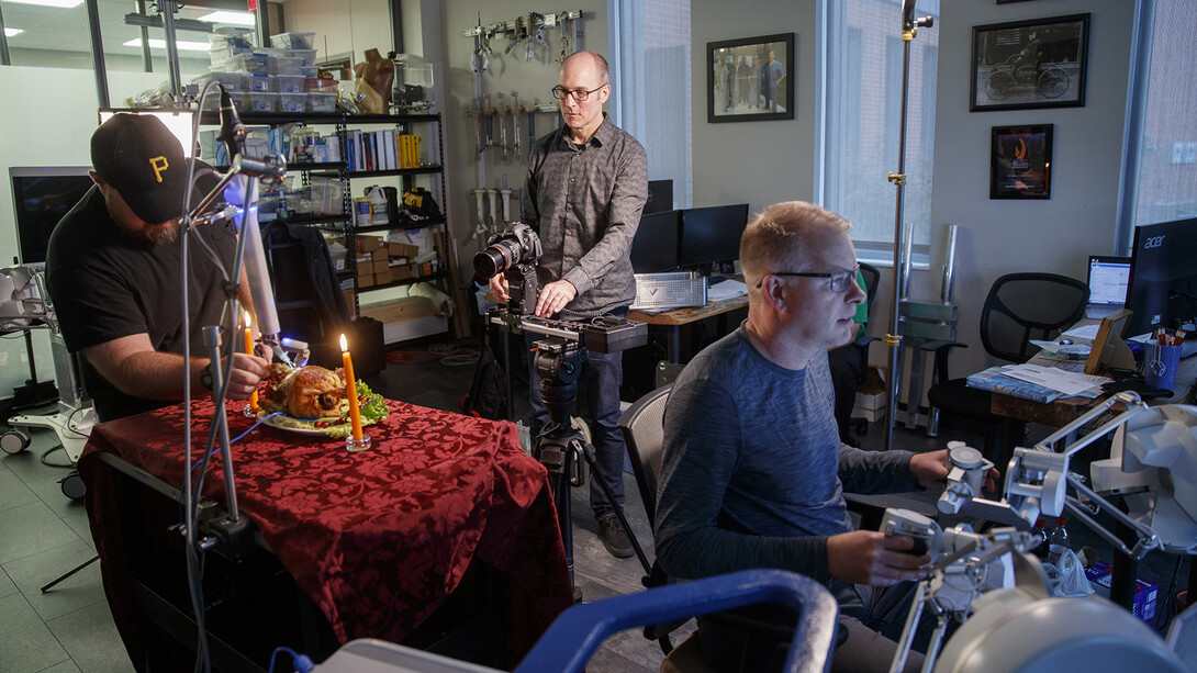 Dave Fitzgibbon prepares to shoot a video with Shane Farritor and an assistant. The shoot was for a Thanksgiving promotion and featured a surgical robot from Virtual Incision carving a chicken.