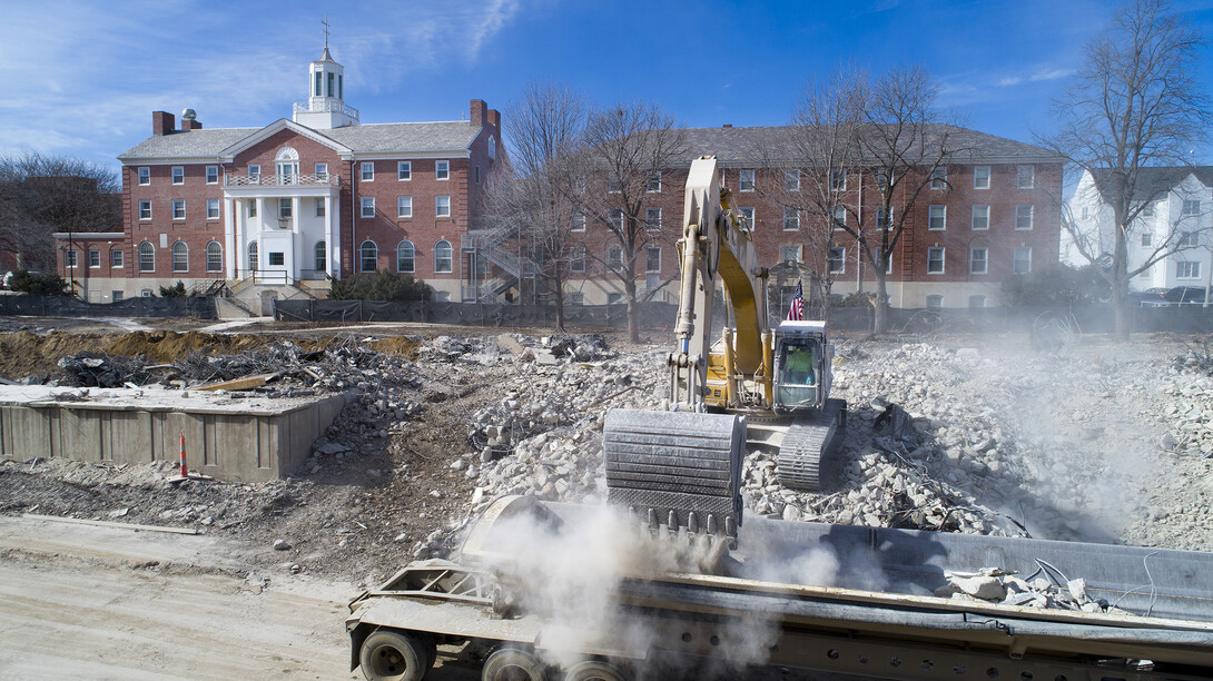 An excavator drops rubble into a truck trailer on the Cather-Pound implosion site. Data gathered during the implosion is being used to help further understand how the collapse of buildings during extreme events — like earthquakes — may affect nearby structures.