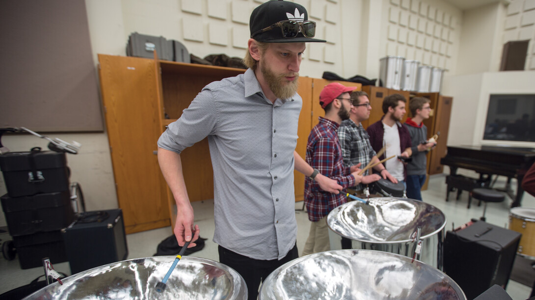 Mike Roe, a graduate student in music, plays a cello (guitar) pan during practice in Westbrook Music Building. Nebraska Steel includes 22 student performers. The ensemble includes two performance groups that can play together or separate.