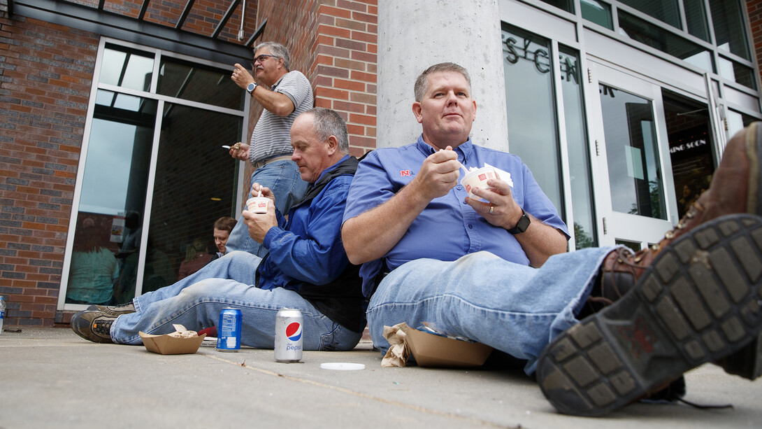 Facilities employees Russ Kraft (right) and Bryan Ludemann enjoy Dairy Store ice cream during the universitywide picnic. Ludemann earned a 10-year Service Award, while Kraft is a seven-year employee at the University of Nebraska–Lincoln.