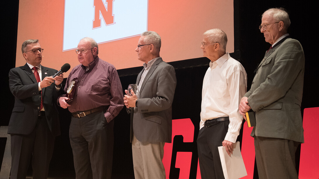 Chancellor Ronnie Green chats with Edward Becker, professor of philosophy during the Celebration of Service. Becker earned a 50-year Service Award. Other 50-year honorees that attended include (from left of Becker) Roger Bruning, Allan Peterson and Brett Ratcliffe.