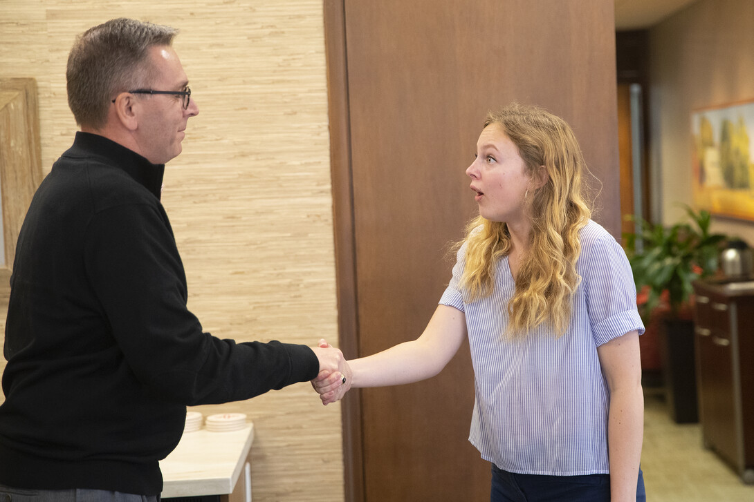 Emily Johnson (left) reacts with surprise as Chancellor Ronnie Green tells her she's been selected as a Harry S. Truman Scholar April 8.