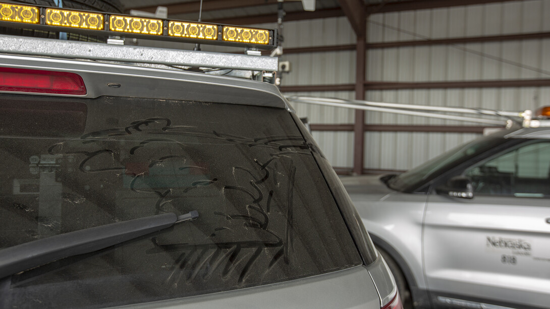 A thunderhead rolls across the dust on the back window of a Nebraska storm chase vehicle. The TORUS research project, which will cover much of the Great Plains in 2019 and 2020, begins May 14.