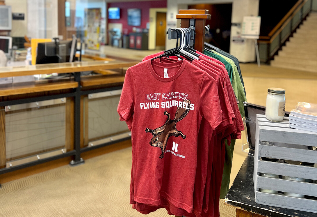 T-shirts featuring flying squirrels hang in the Maps & More store.