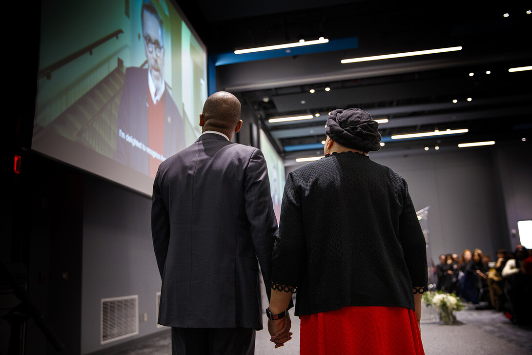 Marco Barker and Anna Shavers watch a video of Chancellor Ronnie Green congratulating Shavers on earning the university’s Fulfilling the Dream award. The honor was presented during the MLK Week brunch.