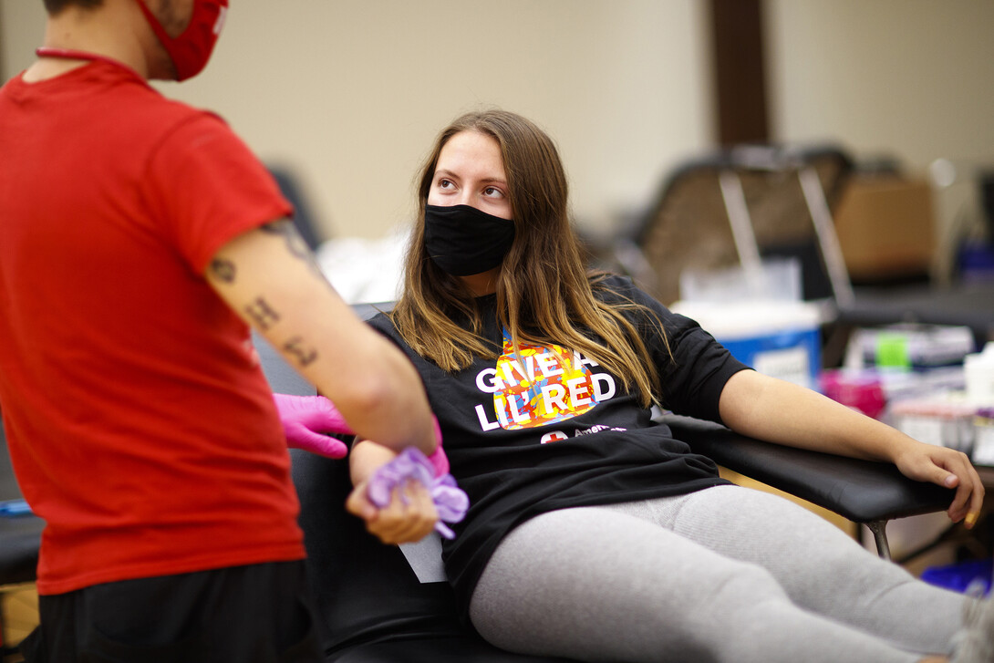 Kacey Heidbrink, a junior from Beatrice, listens to instructions while donating.