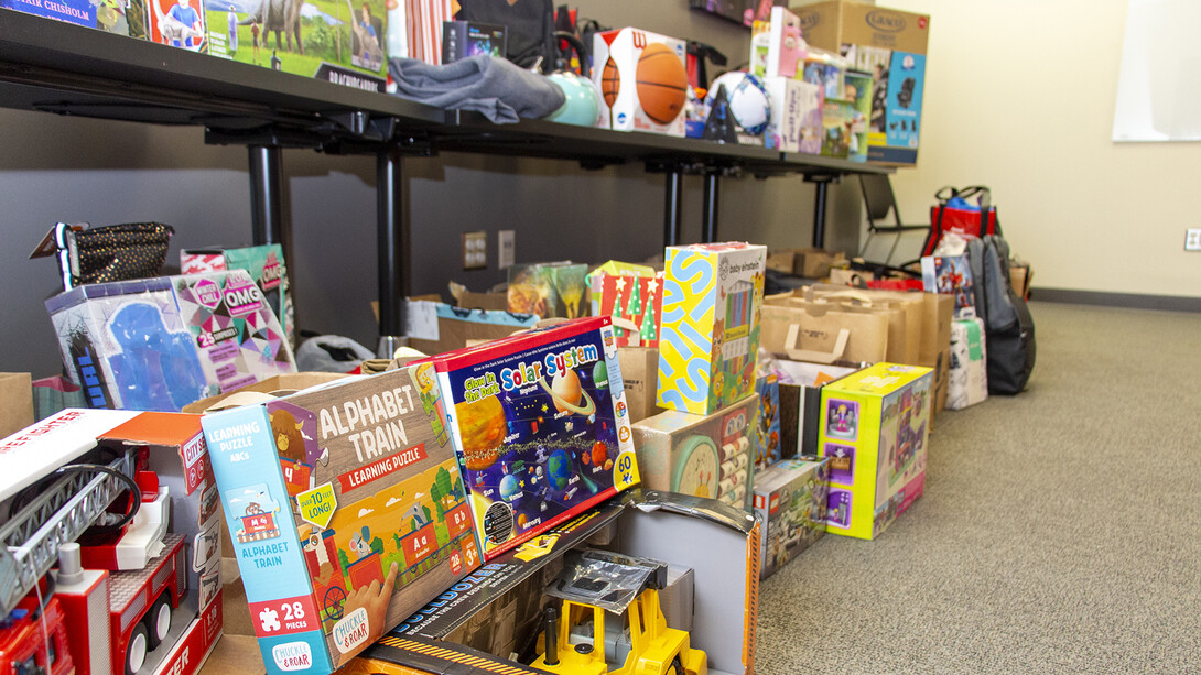 Items collected for the Holidays for Little Huskers program sit read for distribution. The drive collected nearly $4,000 and 100 coats for Husker students in need.