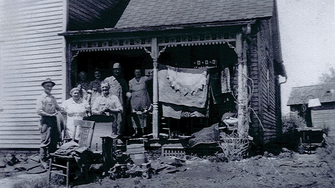 The Winter family stands in front of the original farmhouse. The portion they stand on has since been turned into an addition on the house.