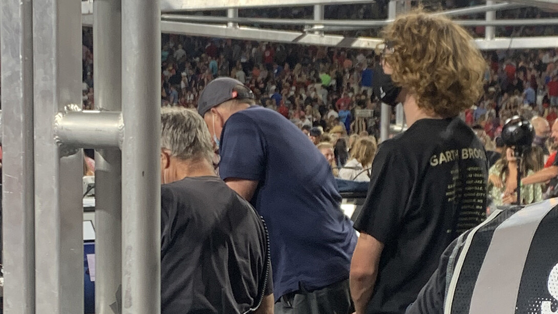 Carson Emeigh (right), a senior mechanical and materials engineering major, works as part of the crew during Garth Brooks' Aug. 14 concert at Memorial Stadium.