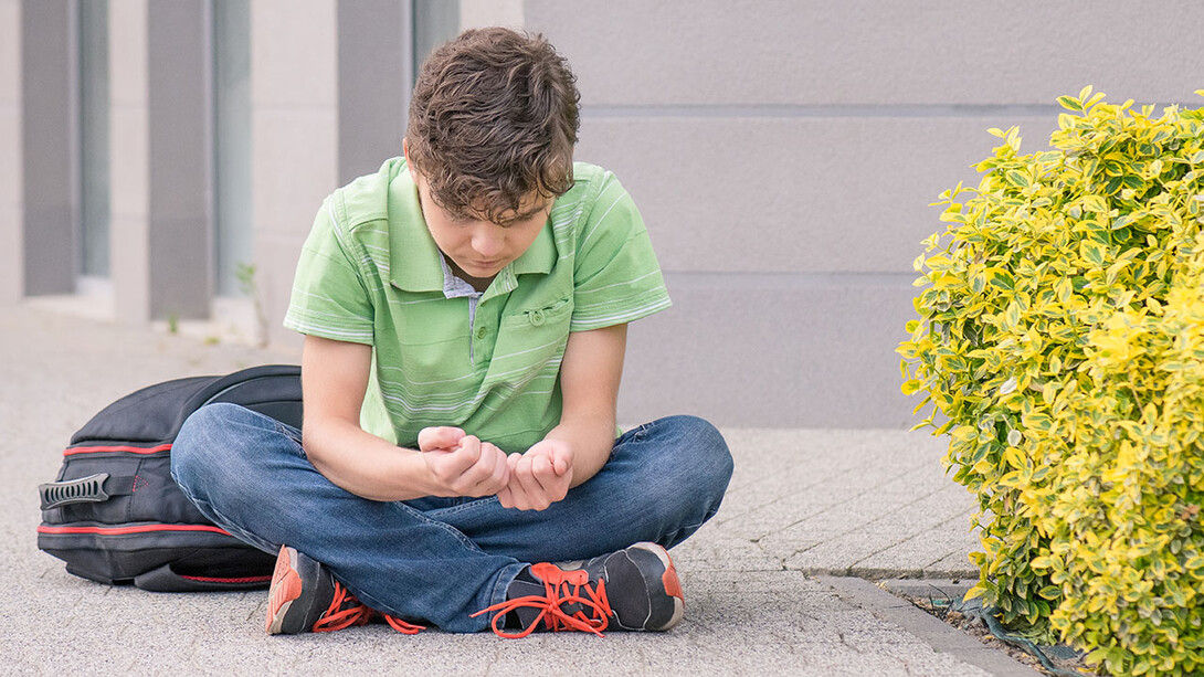 Teen boy looking forlorn