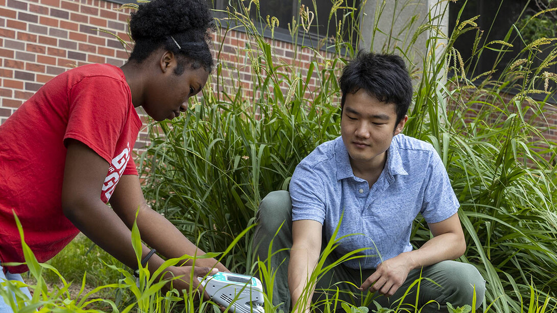 Clementine Ewomsan, a member of the STEM-POWER Research Program’s 2022 summer cohort, works with Yuguo Yang, a graduate student in biological sciences, during her summer research appointment.