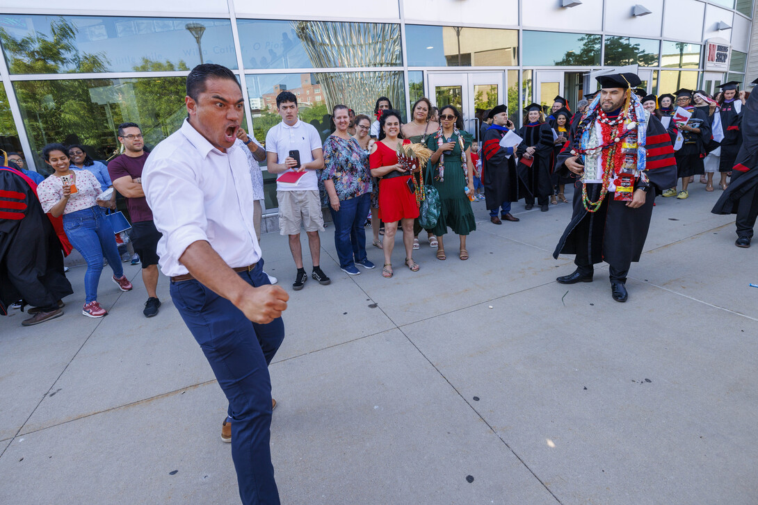 Sone Tuala performs a haka, a ceremonial Māori dance, to honor his brother Maika Malualelagi Tuala, a doctoral graduate, outside of Pinnacle Bank Arena.