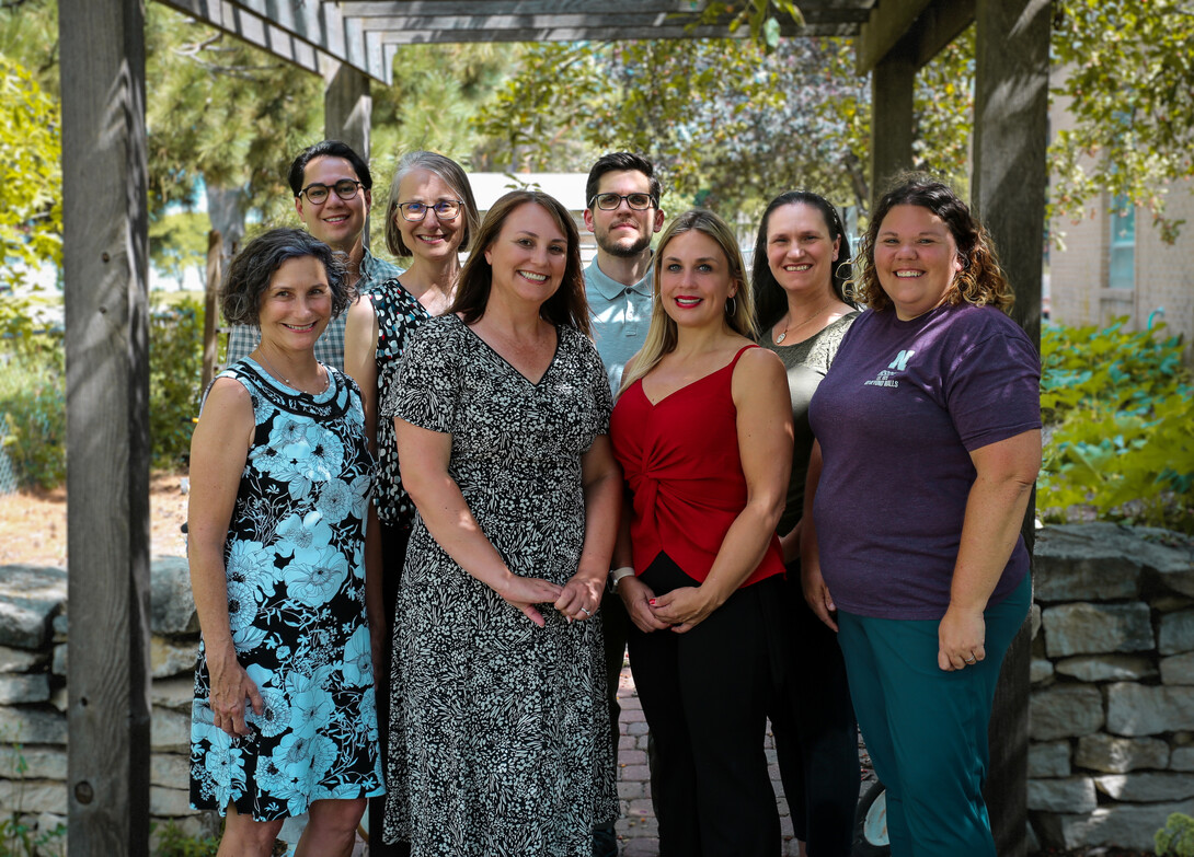 Outdoor group photo with eight Husker researchers