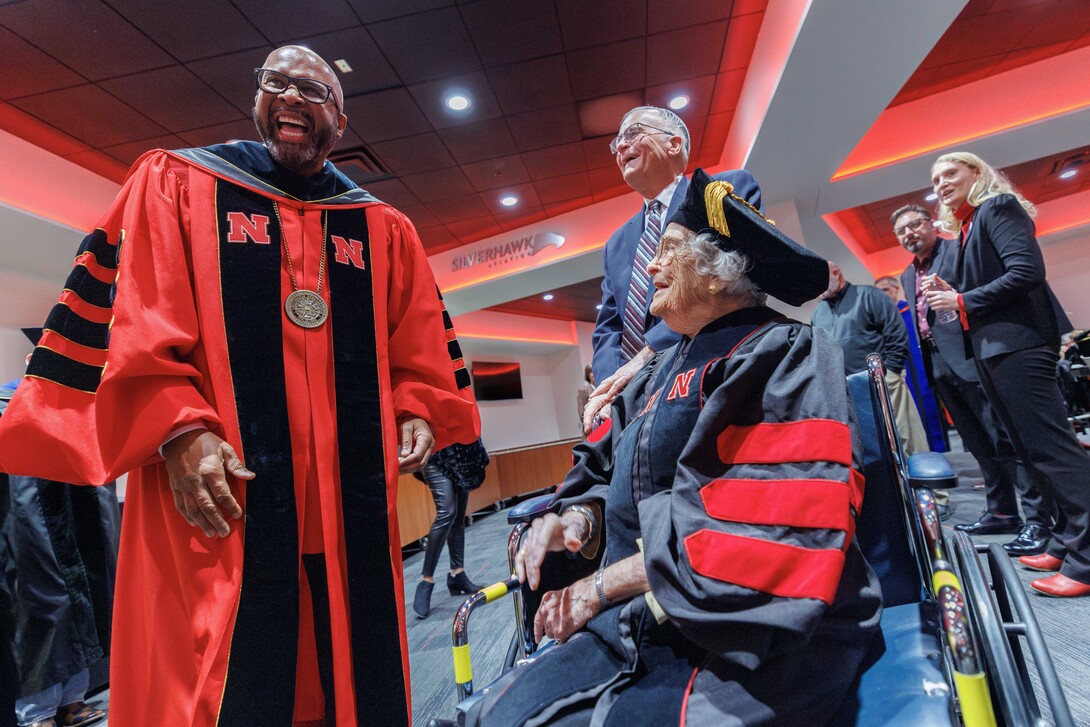 Marion LaVerne (Patton) Larmon shares a laugh with Chancellor Rodney D. Bennett before receiving her honorary Doctor of Fine Arts on Dec. 20.