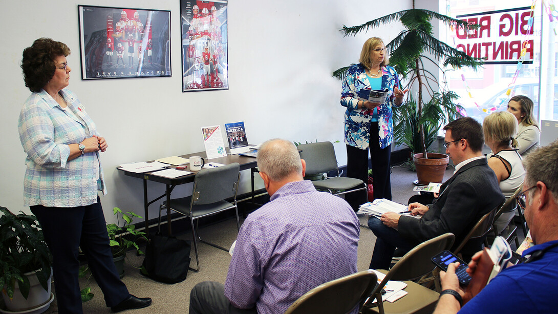 Cheryl Burkhart-Kriesel (left) and Marilyn Schlake give a presentation to at least five people, who are seated.